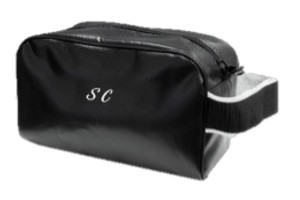 Black leather bag with the initials “SC” printed on it in white.