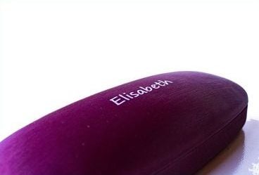 Dark purple glasses case with the name “Elisabeth” printed on it in white lettering in front of a white background.